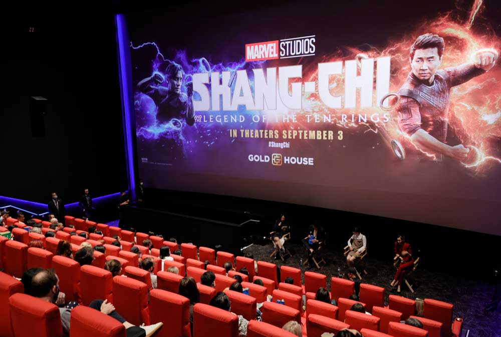 People seated in a theater, screen reads "Skang-Chi" from Marvel Studios