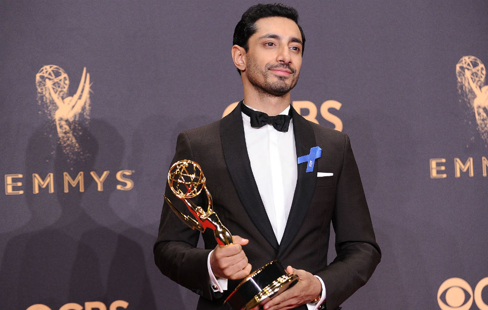 Riz Ahmed holding an emmy at the emmys