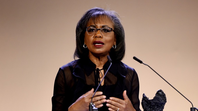 Anita Hill speaking into a microphone