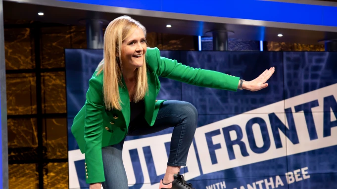Samantha Bee balancing on a desk in TBS's "Full Frontal"