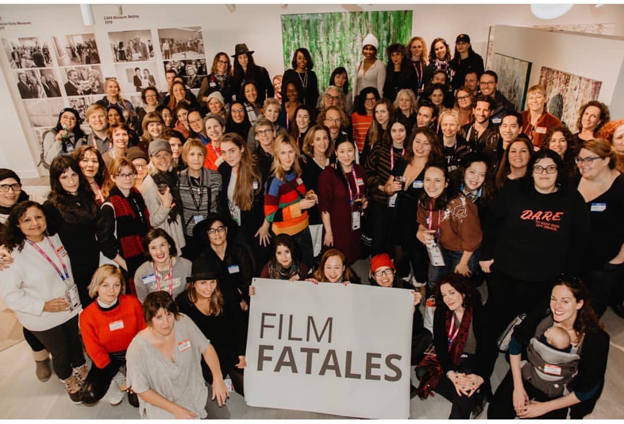 A large group of people posing around a Film Fatales sign