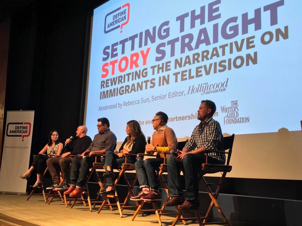 6 people speaking on a panel in front of a Define American logo screen